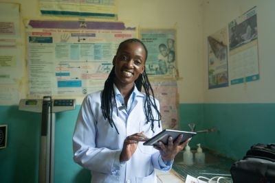 Healthcare worker in Kenya using digital tablet in clinic setting