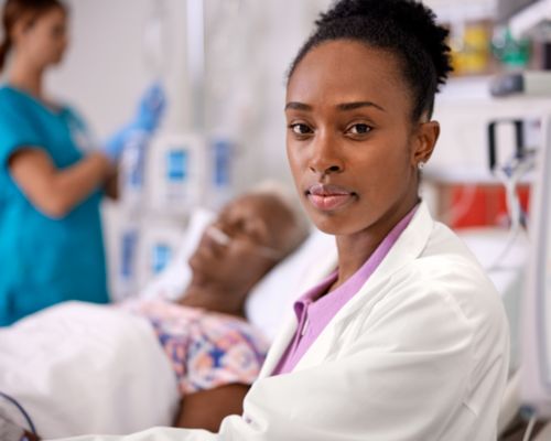 Nurse caring for female patient in ICU, Neuron on wall