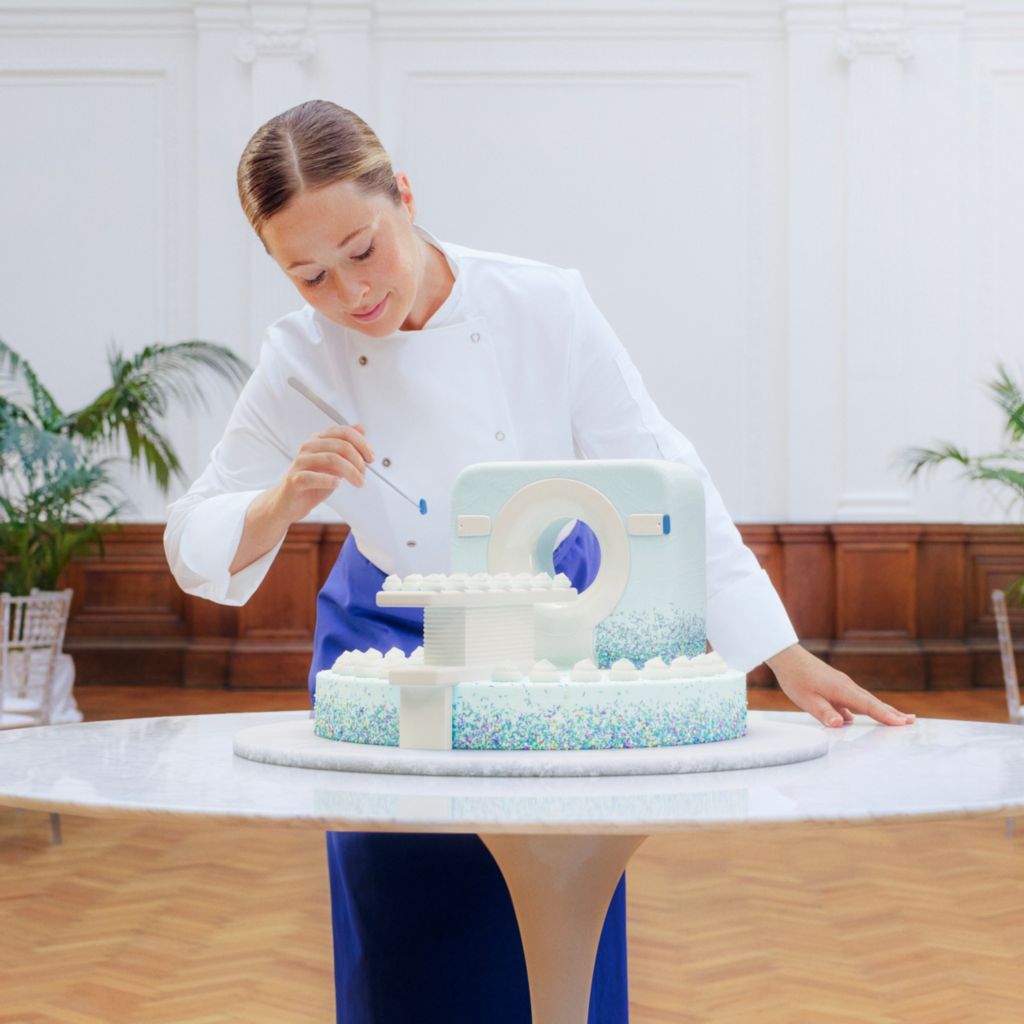 pastry chef decorating ct-shaped wedding cake
