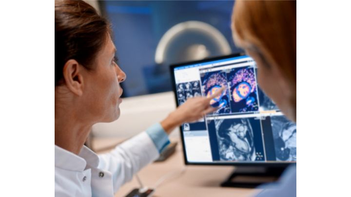 Woman pointing scans on monitor