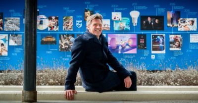 Mark Johnson standing in front of Philips innovation timeline display