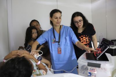 Healthcare workers conducting a child ultrasound examination in Indonesia