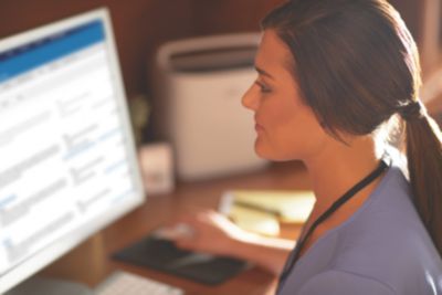 Care Orchestrator In-Use, clinician reviewing patient data on monitor