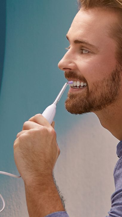 Woman using a Cordless Power Flosser