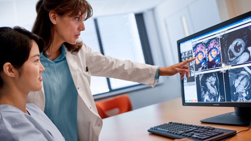 Radiologists look at a cardiac exam on a monitor.