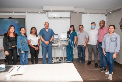 Multidisciplinary healthcare team with patient monitoring equipment in clinical setting