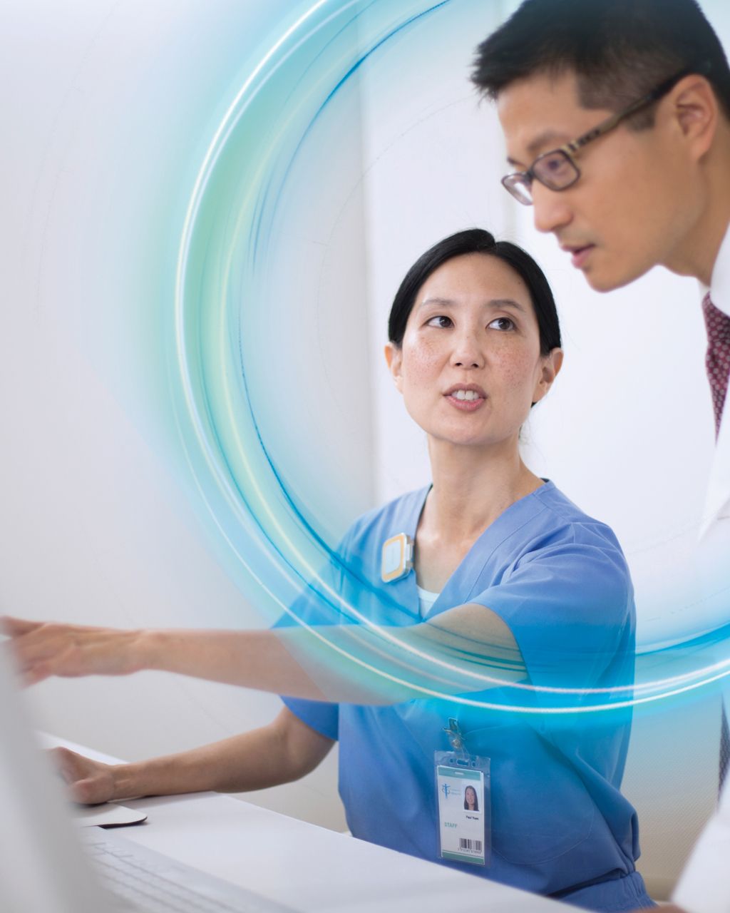 Clinicians conferring at workstation