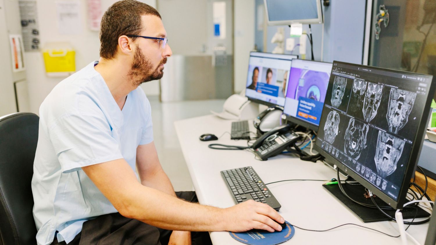 Jack Feeney, head of MRI at Royal Darwin Hospital behind the screen looking at MR images