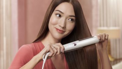 Woman Straightening Hair