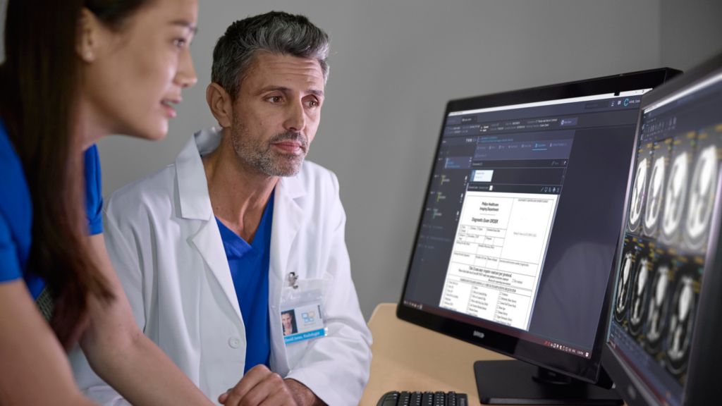 Radiologist and tech conferring