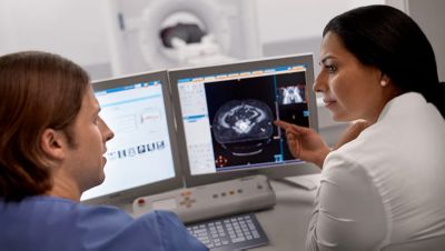Healthcare professionals reviewing patient data on digital monitoring screens