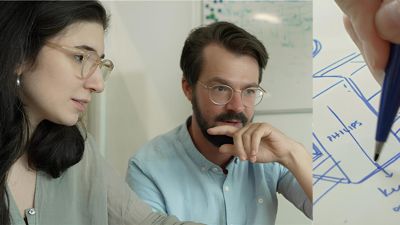 Two designers collaborating over a concept sketch for a Philips product design