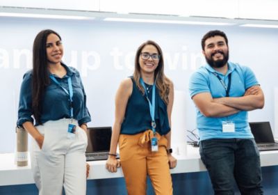 Three Philips employees standing together in a Philips office