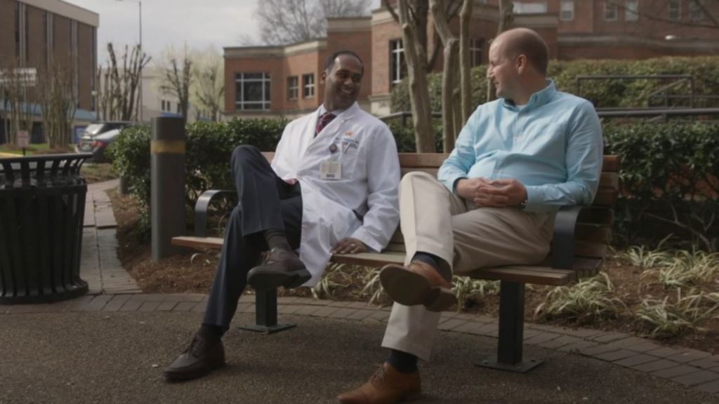 Physician and patient on bench talking
