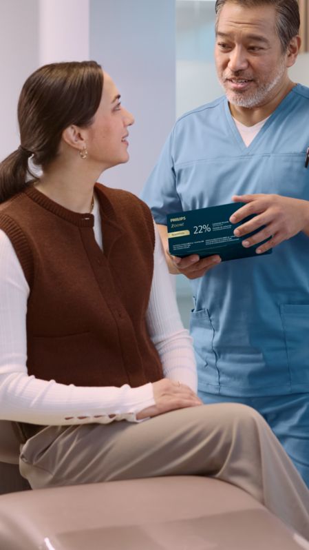 Woman placing a Phlips Zoom! take-home whitening tray