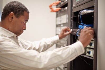 Tech professional working at wireless servers in data center