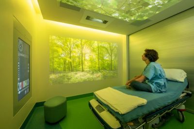 Pediatric patient relaxing while viewing nature scene in Ambient Experience room