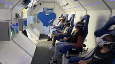 Children experiencing virtual space journey using virtual reality headsets