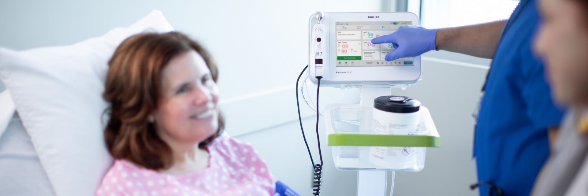 Nurse uses VS30 vital signs monitor with patient