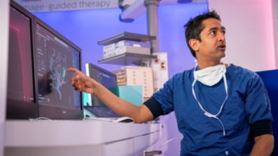 Atul Gupta reviewing brain imaging during image-guided therapy procedure
