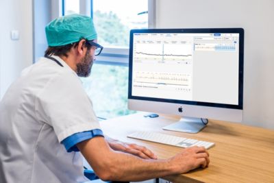 A cardiologist monitoring patient data