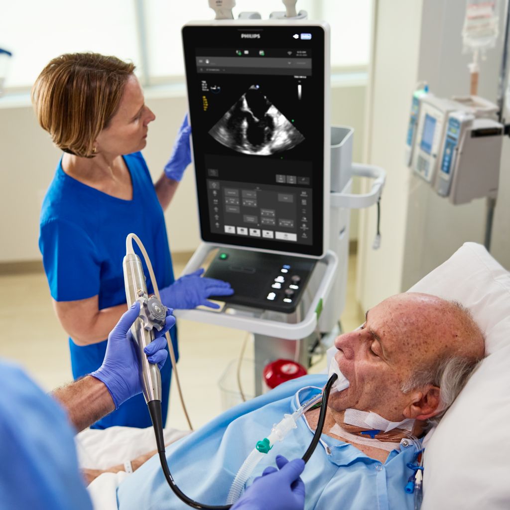 Clinician performing TEE ultrasound scan on critical care patient.  