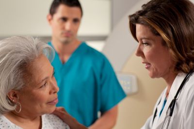 Healthcare professionals having a discussion with a patient.