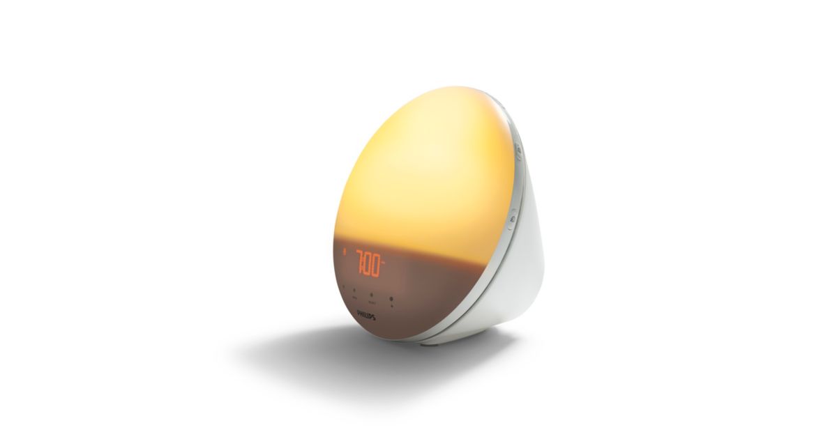 Lámpara despertador Philips SmartSleep HF3531 con la pantalla circular iluminada en tono ámbar.