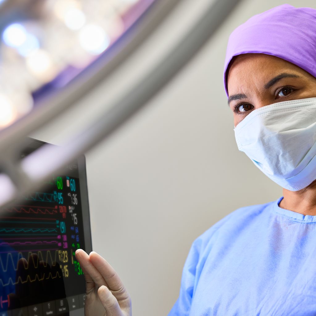 Hero clinician interacting with patient monitor 6000 in the OR