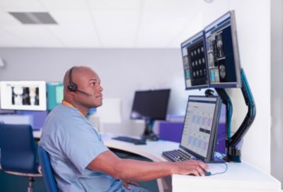 A radiology technologist monitoring exams remotely