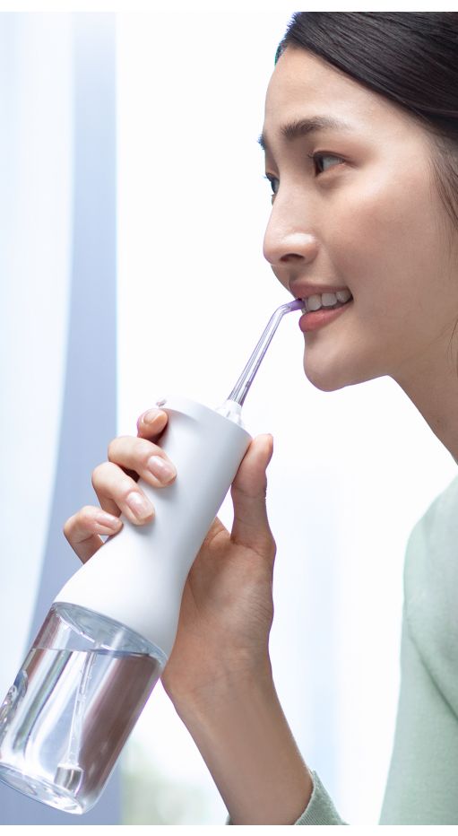Woman using a Cordless Power Flosser