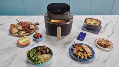 Airfryer with prepared dishes on kitchen counter