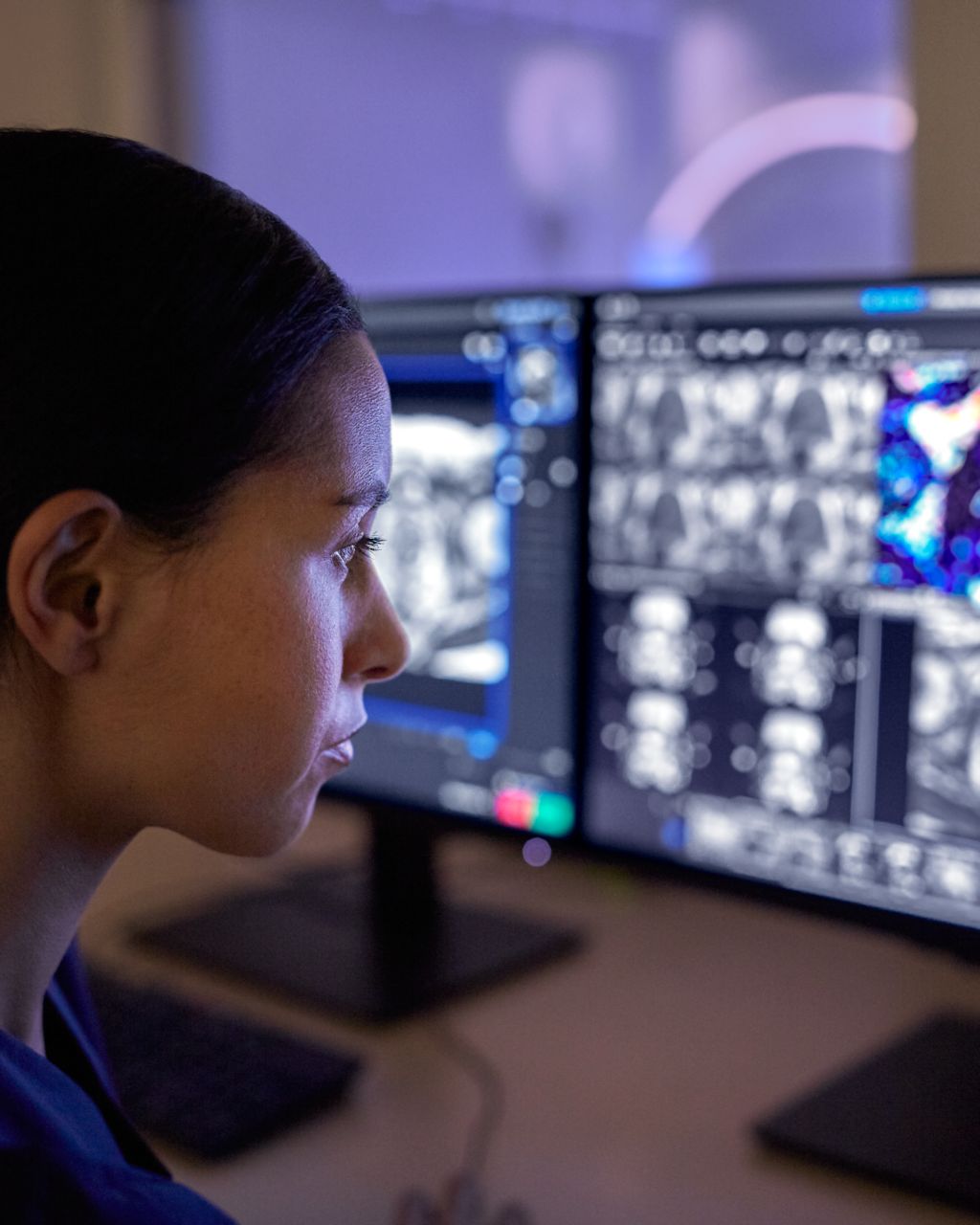 Clinician reviewing multiple screens. 