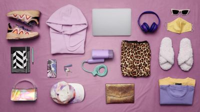 Travel pack list with handheld steamer and personal items laid out