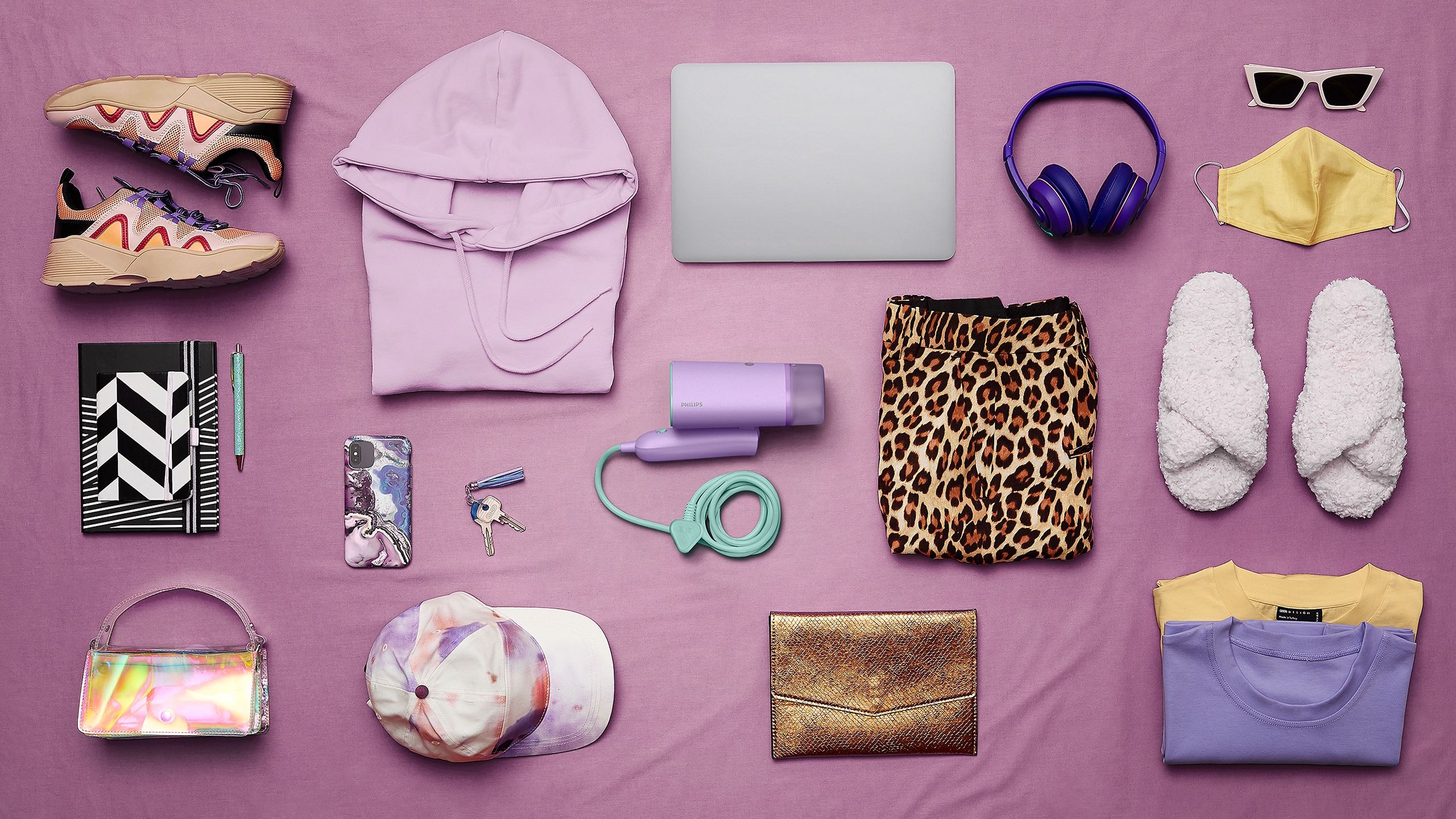 Travel pack list with handheld steamer and personal items laid out