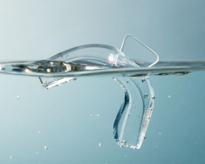 A patient holding a whitening tray before molding