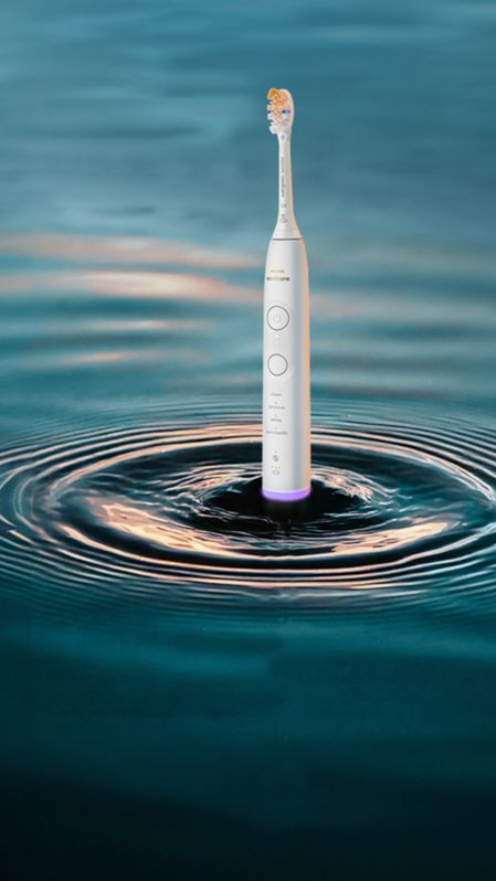 A Philips Sonicare 7400 standing with ripples surrounding it