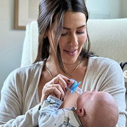 Mother bottle feeding baby