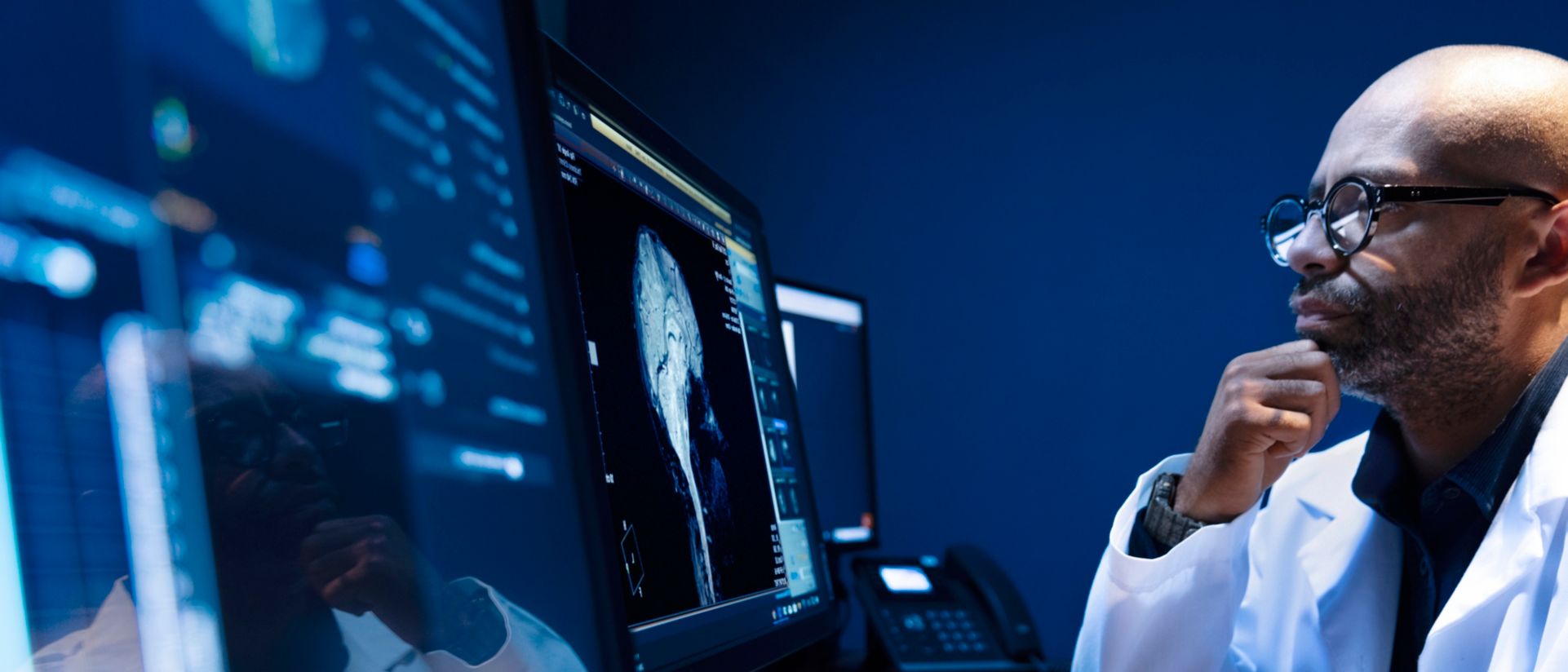 Medical professional reviewing scan on monitor