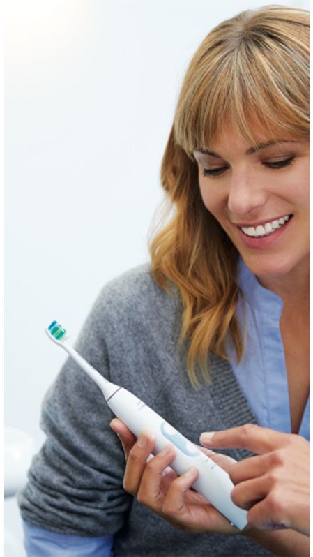 Dental professional showing how to brush Sonicare power.