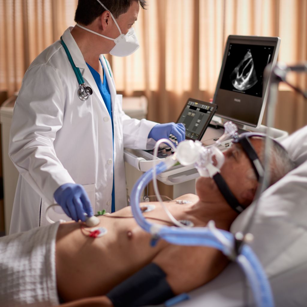Compact 5000 Series shown in critical care setting with a physician performing a cardiac scan