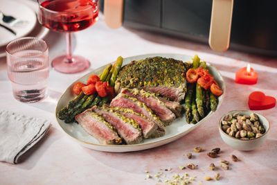Rib eye steak with pistachio crust served with asparagus