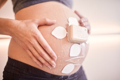 Mom in shower with beltless pod and patch