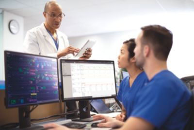A care team discussing patient monitoring data