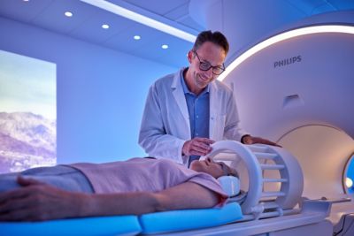 Radiologist preparing patient for brain mri scan on advanced system