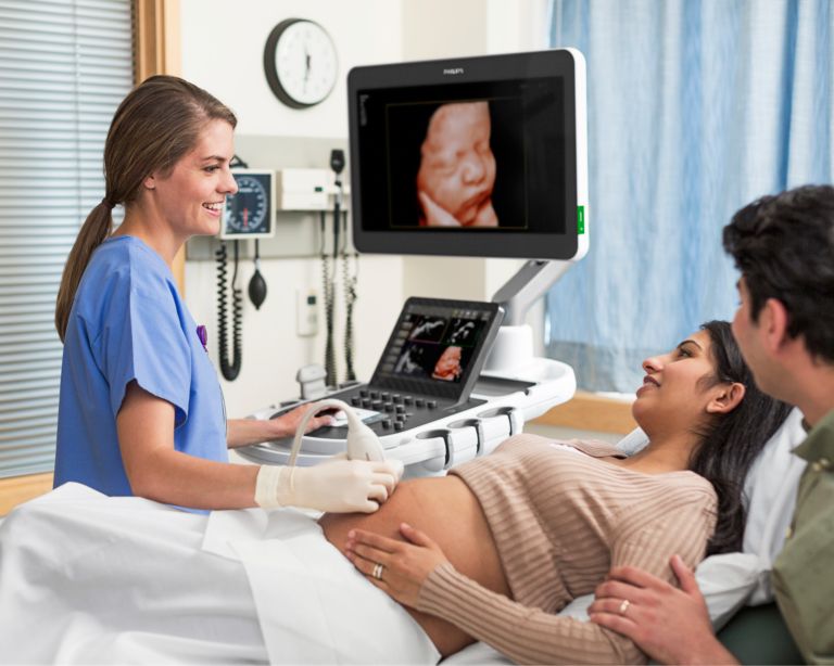 Clinician conducting OB scan on patient with an EPIQ system and a V9-2 trasnducer. Image shown utilizes TrueVue technology.