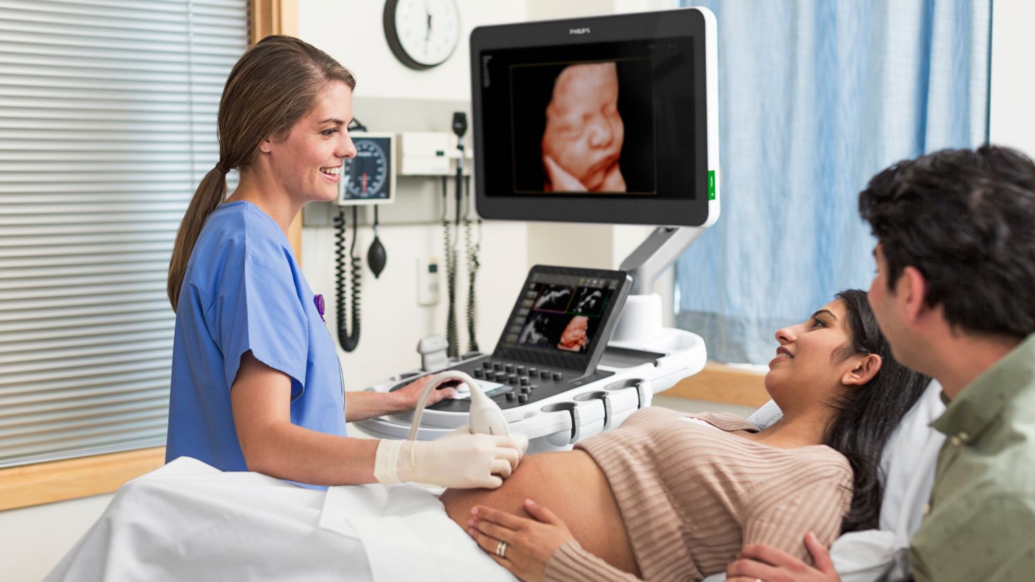 Clinician conducting OB scan on patient with an EPIQ system and a V9-2 trasnducer. Image shown utilizes TrueVue technology.