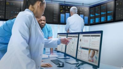 A doctor discussing medical results with two healthcare professionals