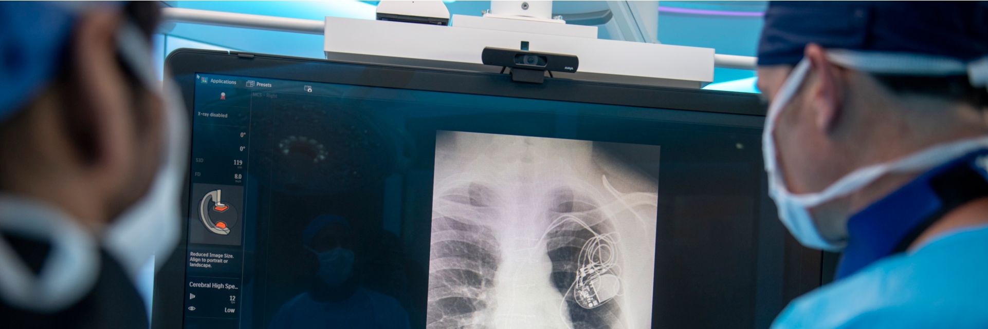 Clinicians reviewing monitor of x-ray image
