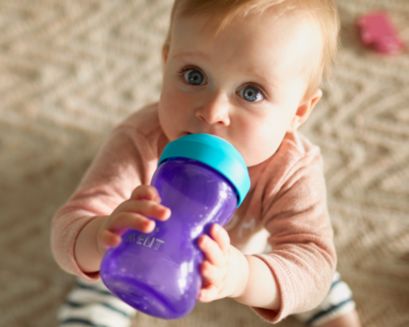 Baby holding a sippy cup